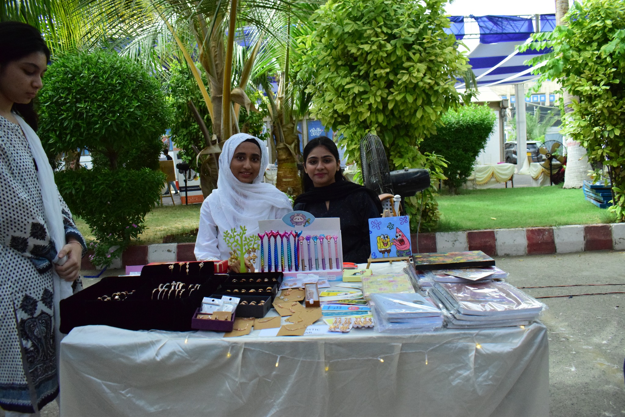 Young entrepreneurs showcasing accessories and small products